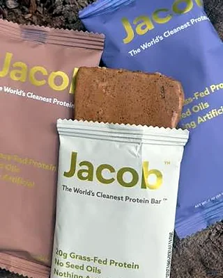 Three Jacob protein bars on wood, one open
