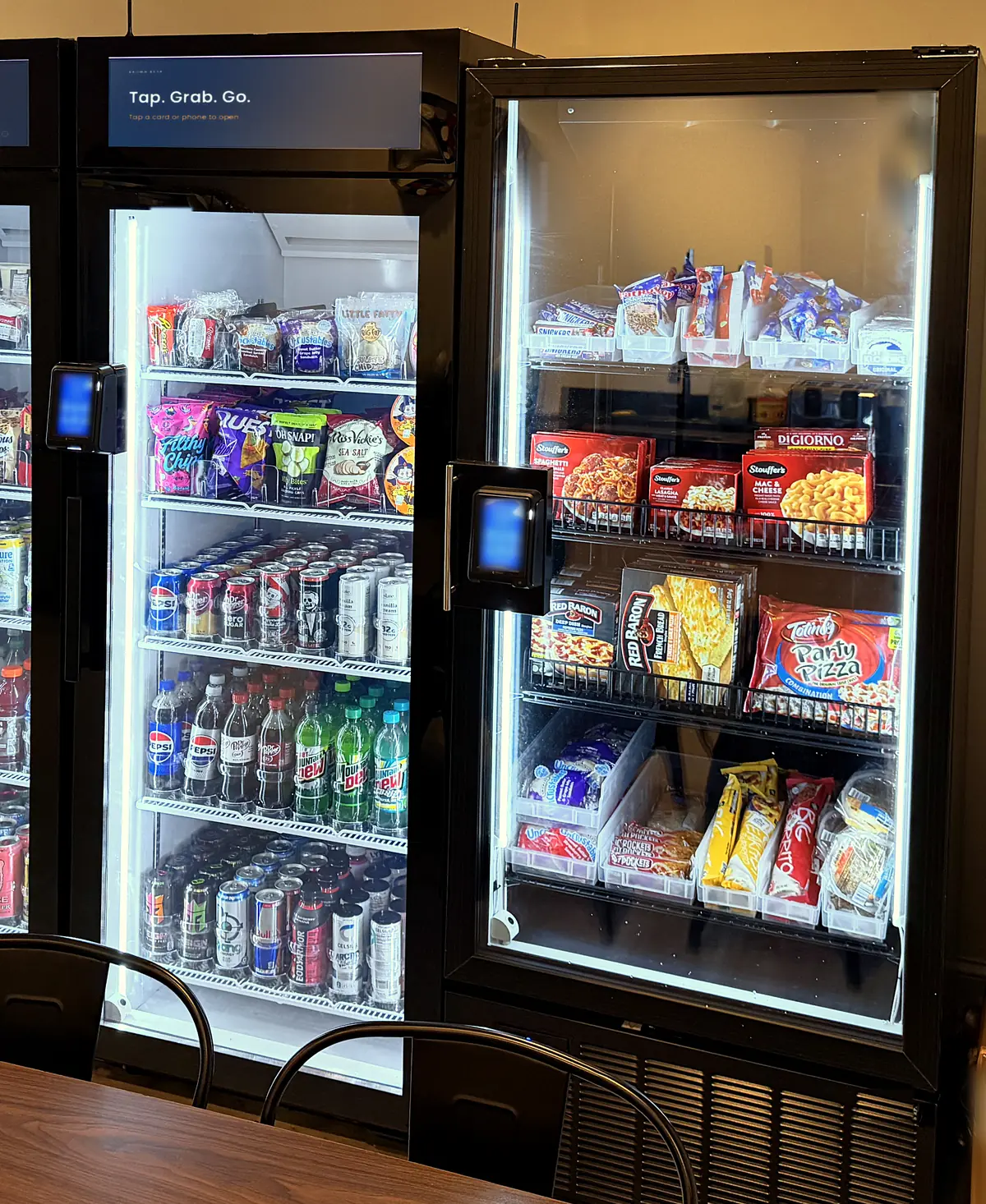 Brown Bear smart coolers in a break room: snacks and cold drinks in one, frozen meals in the other, with tap-to-pay readers on the doors.