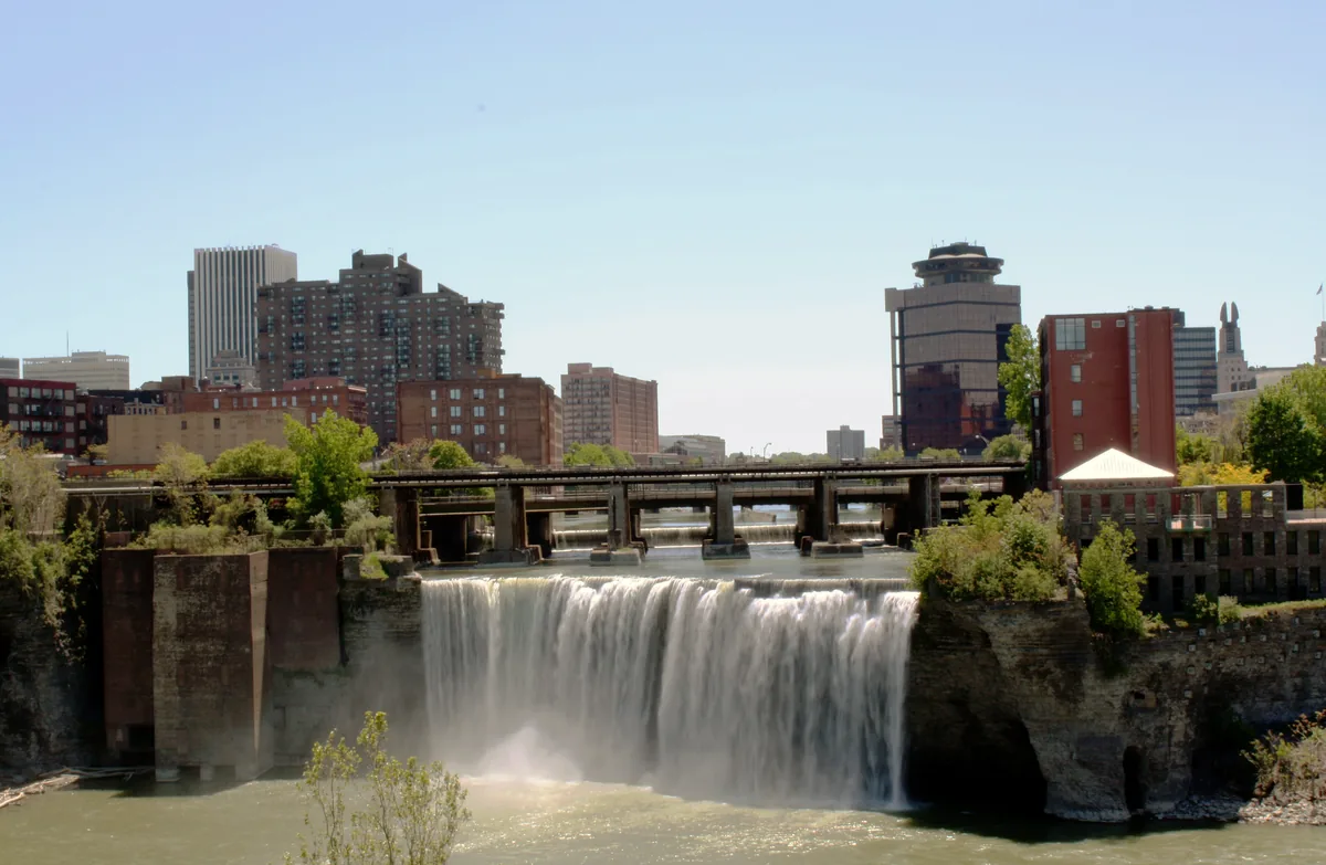 High Falls on the Genesee River with the downtown Rochester skyline behind it.